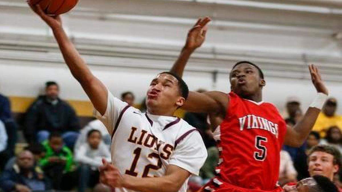 
Jalen Knight (12) drives to the basket against Northwest Guilford during the first half of West Charlotte’s N.C. 4A boys’ sectional basketball championship victory Tuesday night. 
