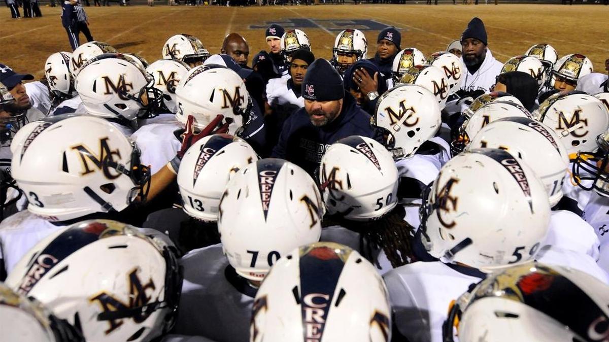 Mallard Creek Mavericks head coach Mike Palmieri, center, calls his team together prior to overtime action vs East Forsyth in Kernersville, NC on Friday, December 4, 2015. Mallard Creek and East Forsyth faced one another in N.C. 4AA Western Regional final action. Mallard Creek defeated East Forsyth 41-38.
