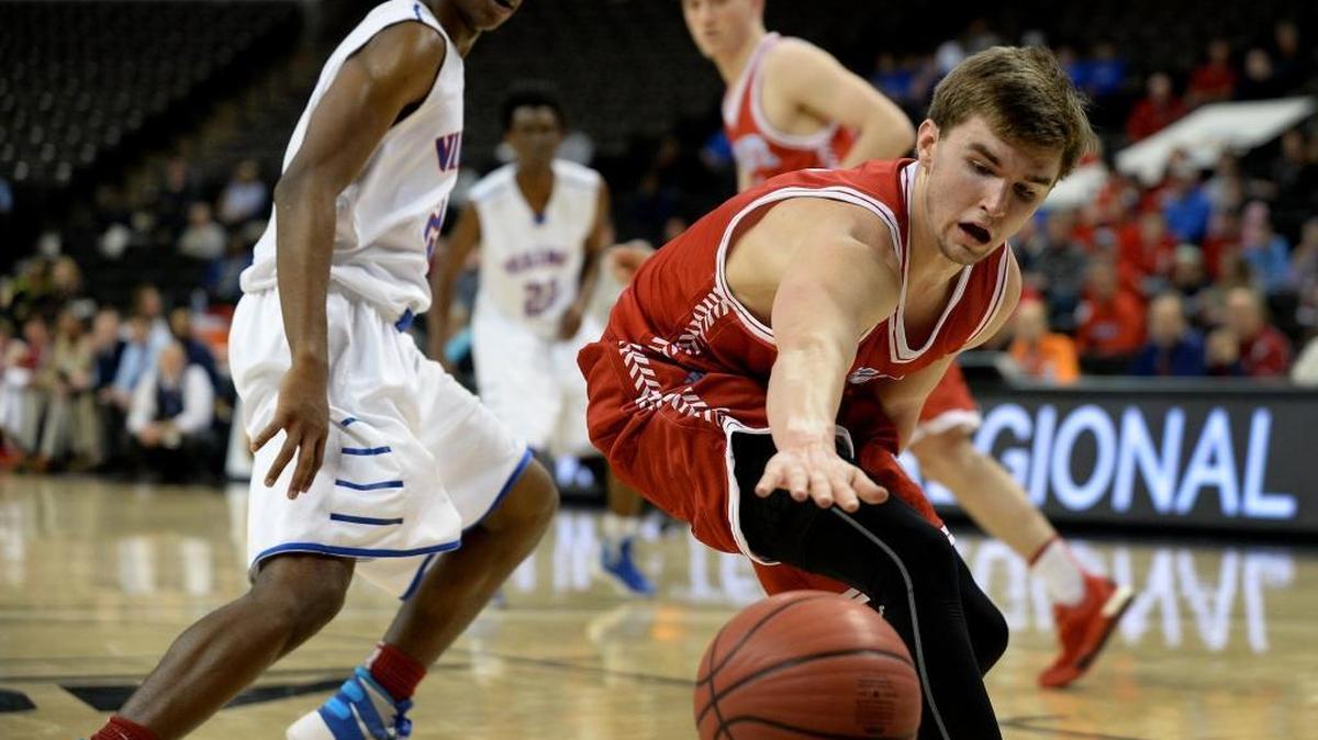 Charlotte Catholic guard Jack Larkin chases a loose ball against North Mecklenburg in the N.C. 4A boys’ regional final Saturday in Winston-Salem. Larkin scored a game-high 19 points, had six rebounds and two steals in the Cougars’ 46-41 win against the Vikings.