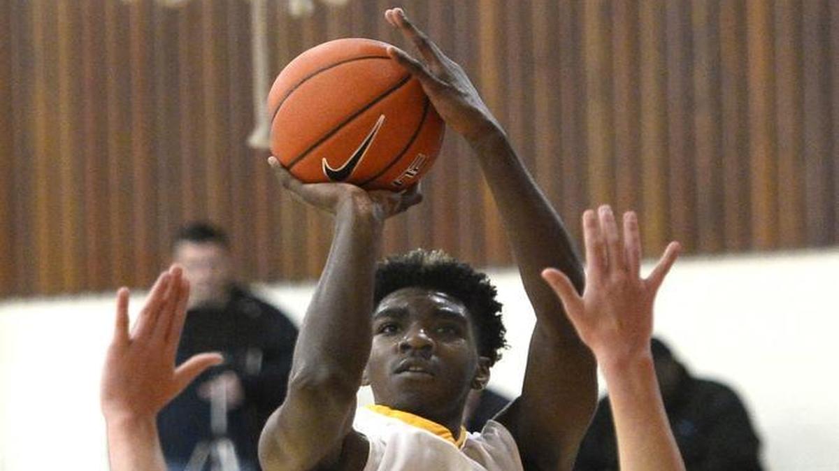 West Charlotte's Patrick Williams (4) shoots over Dawson Christian's Luke Chism (32) during their game in the Queen City Jingle Bell Tournament at Olympic High on Thursday, December 22, 2016.