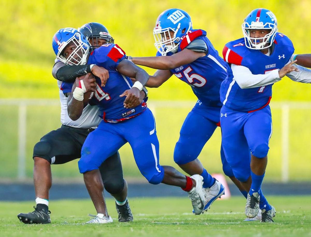 North Meck running back Fabian Duncan tries to break a tackle against Cox Mill in Wednesday’s football game in Huntersville. Duncan and the Vikings won 43-24.