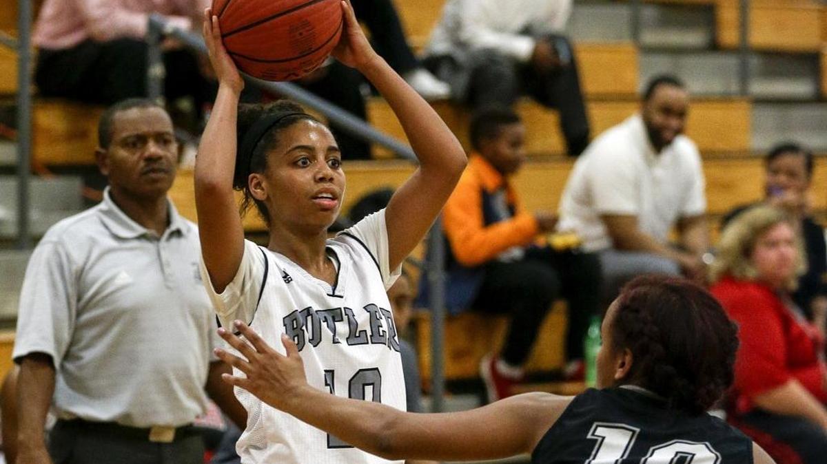 Butler High girls basketball player Fairen Sutton looks to pass over Hough's Karla Thompson. Sutton had open heart surgery two years ago after receiving a free screening from CMS.