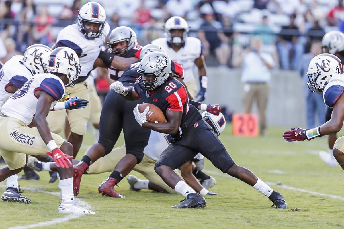 Butler’s Jamal Worthy (20) picks up a first down against Mallard Creek’s defense Friday night.