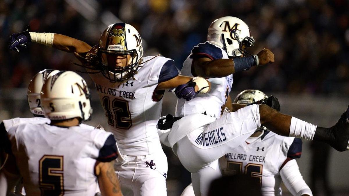 Mallard Creek Mavericks wide receiver Corey Sutton, left, and quarterback James Smith, right, celebrate their touchdown pass and reception during NC 4AA playoff action vs Hough at Hough High School on Friday.