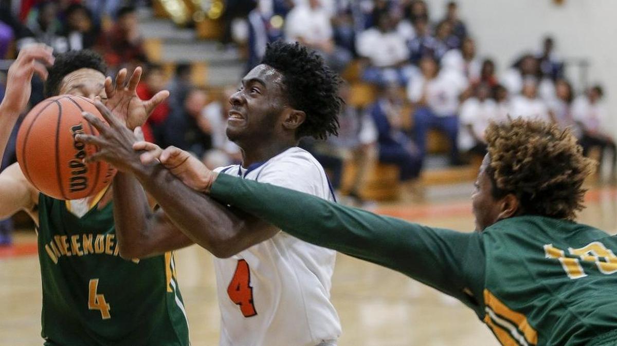 Vance guard Cameron Hamilton, center, drives to the basket against Independence guard Chea Johnson, left, and forward Victor Tshiona in the first half of a high school basketball game Friday, Dec. 4, 2015. (Nell Redmond photo)