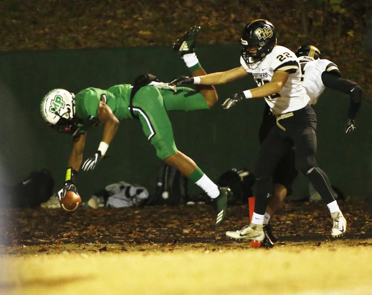 Myers Park wide receiver Moose Muhammad dives for a touchdown against Providence linebacker Peyton Pounds in their first-round playoff game on Friday.