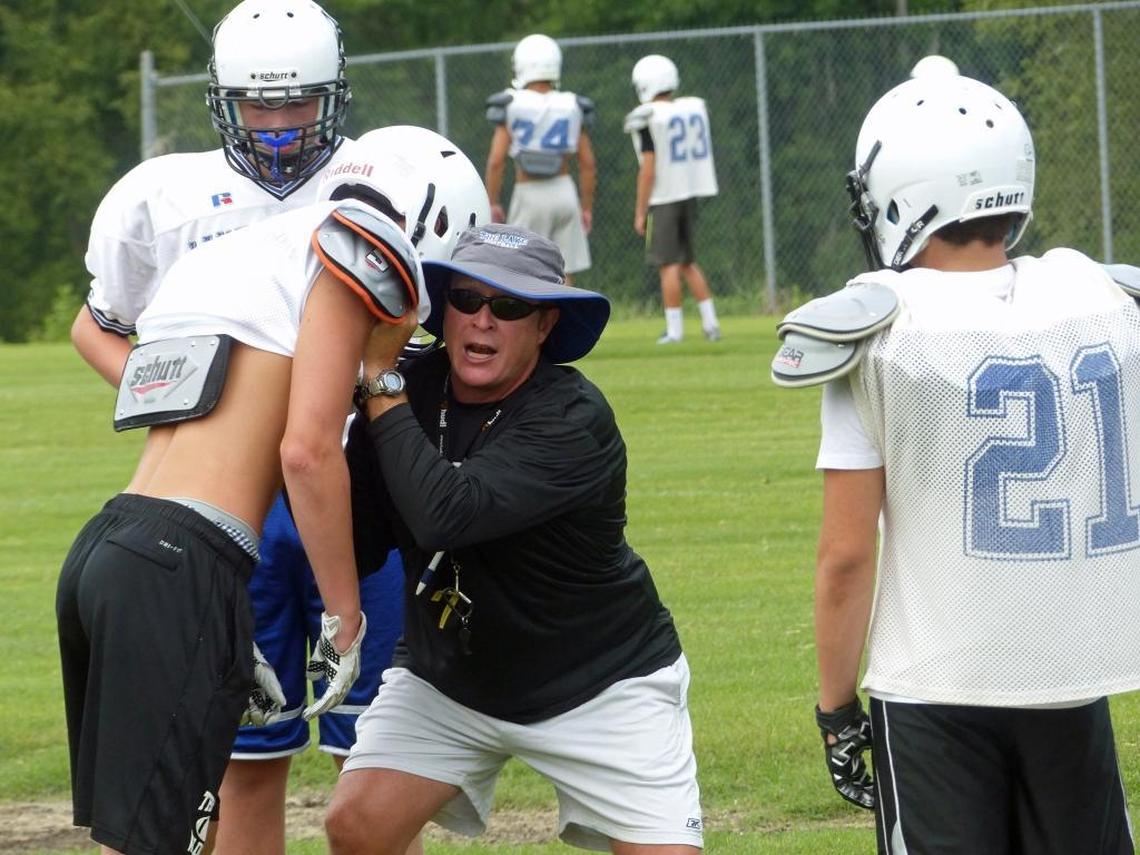 Lake Norman High head coach Rob McNeely (center, in black) is leaving for a job in South Carolina