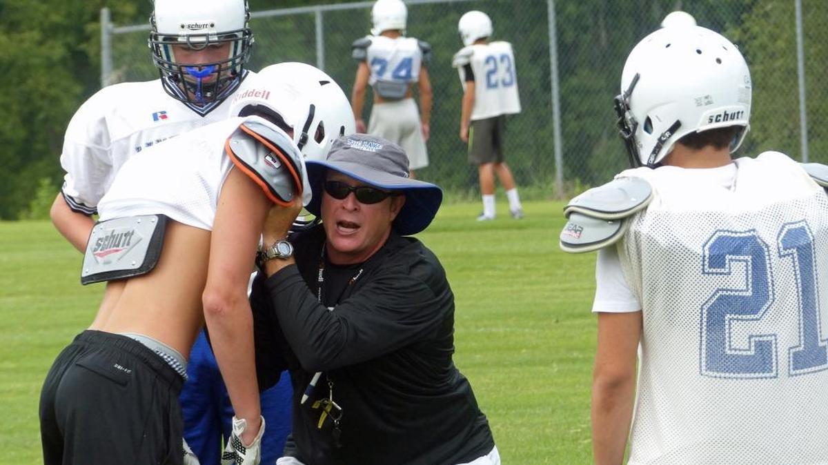 Lake Norman High head coach Rob McNeely (center, in black) is leaving for a job in South Carolina