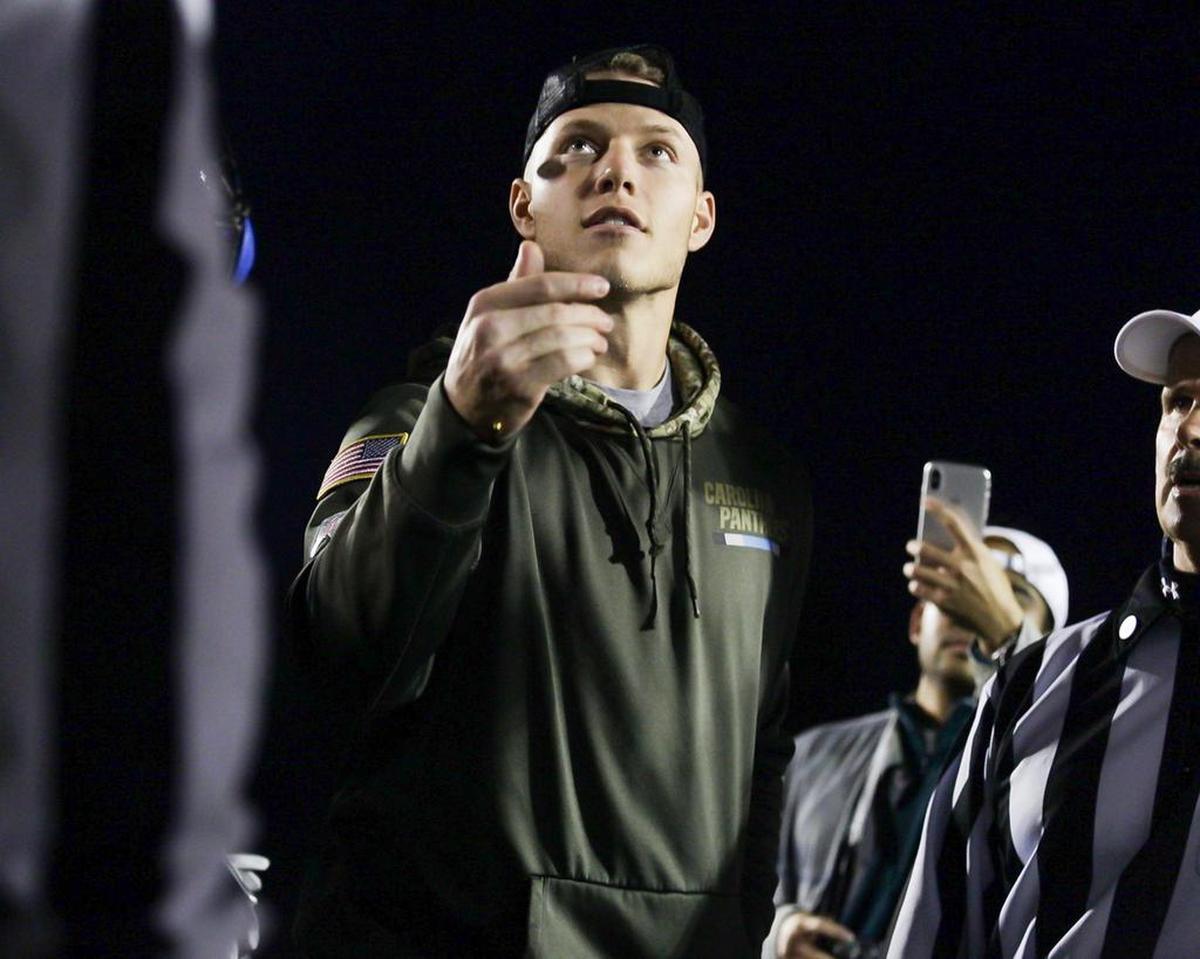 Carolina Panthers RB Christian McCaffrey tosses the coin before Friday’s Hough-Mallard Creek game.