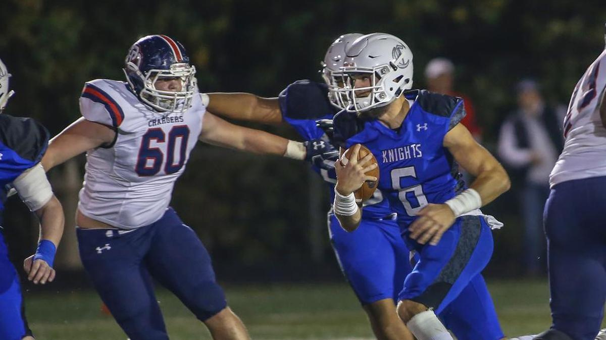 Charlotte Christian quarterback Garrett Shrader, right, runs for yardage against Providence Day in the first quarter of Friday’s game.
