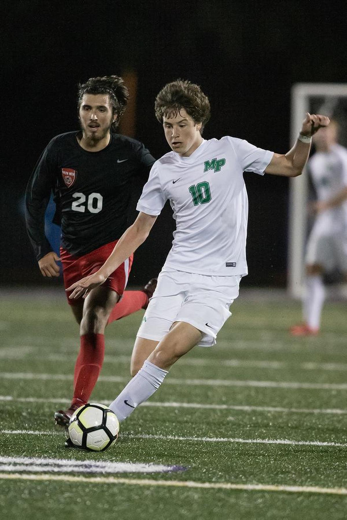 Myers Park’s Carter Hensley (10) dribbles the ball through the midfield.