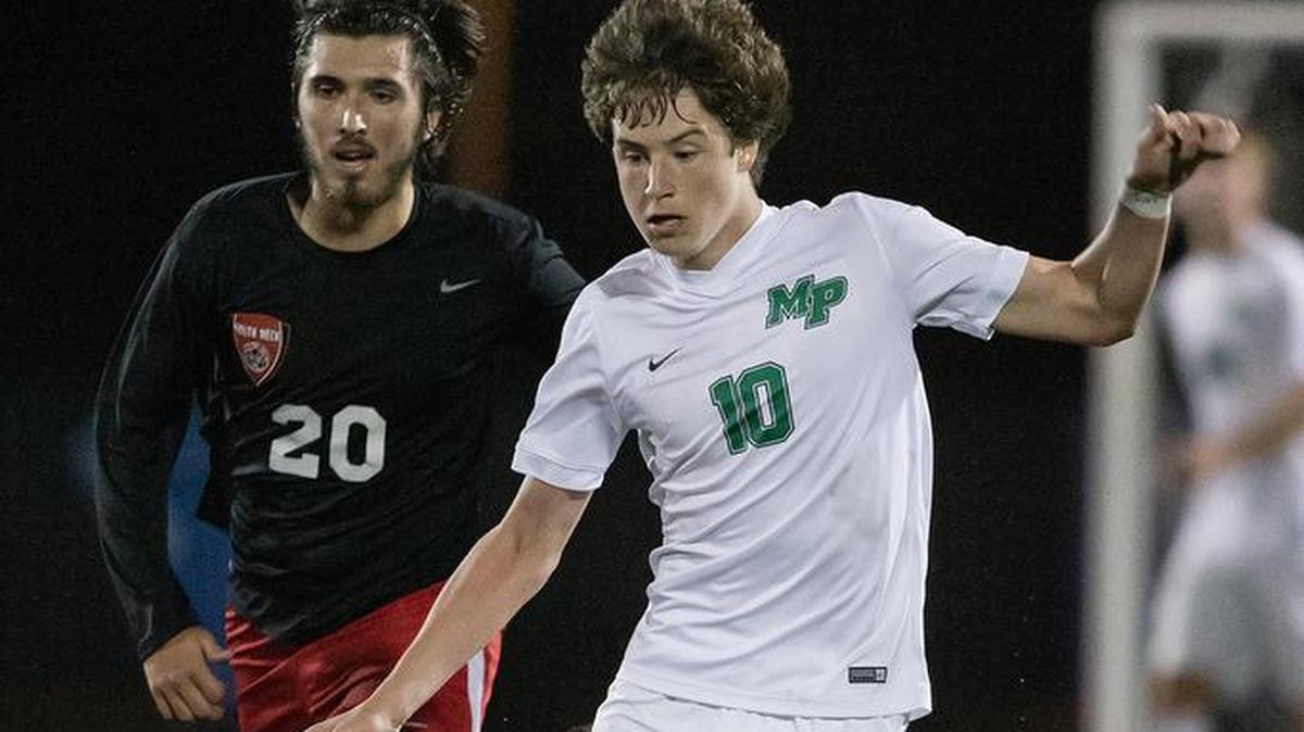 Myers Park’s Hensley Carter (10) dribbles the ball through the midfield.