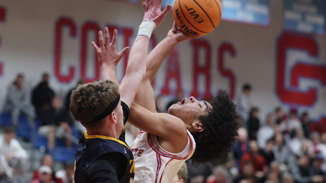 Charlotte Catholic School point guard Mack Jordan shoots against Mount Tabor point guard Aidan O'Gara Monday, March 2, 2026 at Charlotte Catholic High School.