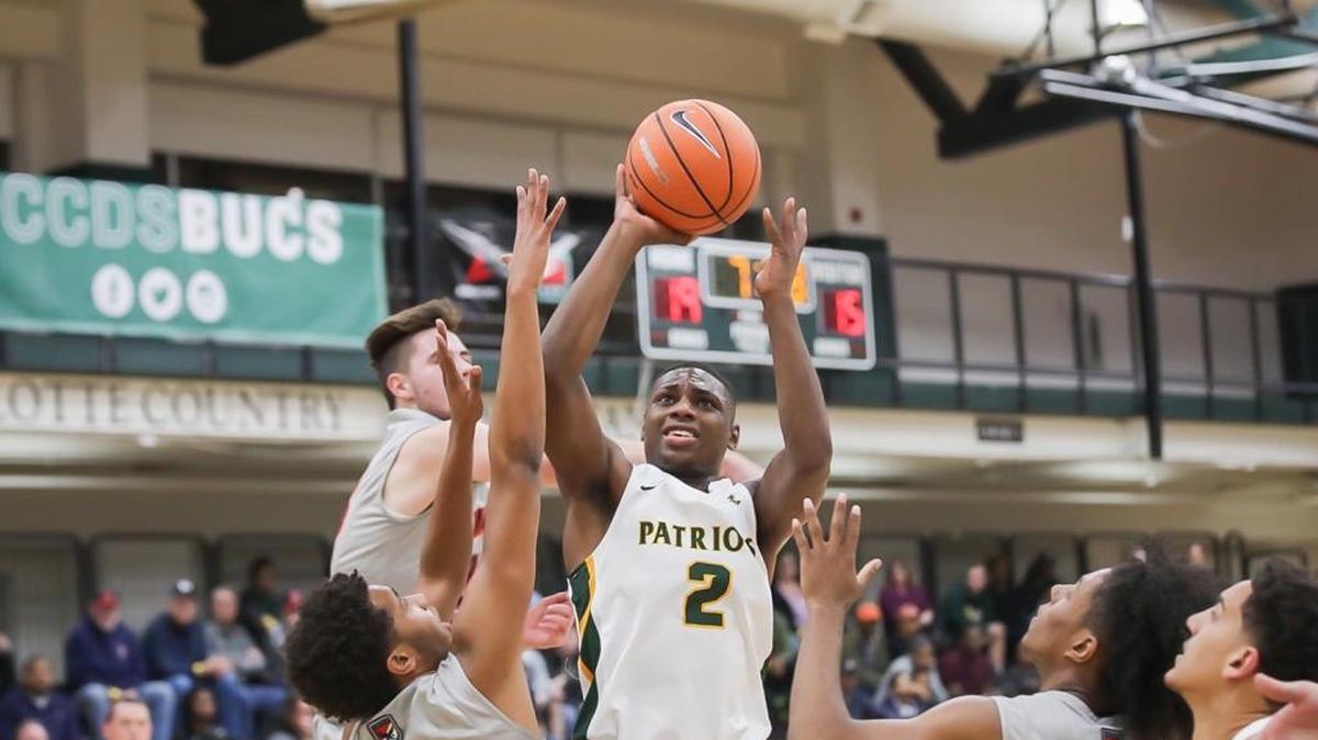 Independence's Jamarius Burton drives the lane and pulls up for a two point basket against a number of Lincoln Charter defenders. BSN Sports Queen City Clash December 21, 2017.
