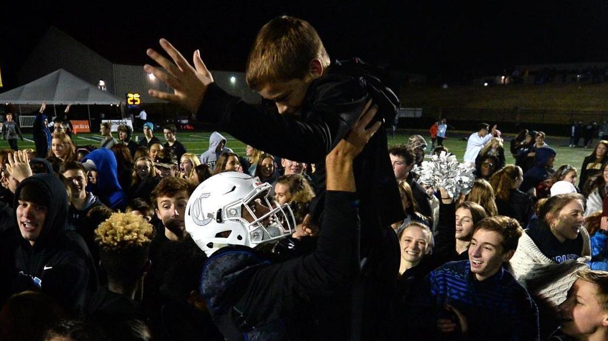 Charlotte Christian Knights quarterback Garrett Shrader, center, celebrates the team's state championship win over Providence Day last month. Shrader is a first team All-Mecklenburg quarterback