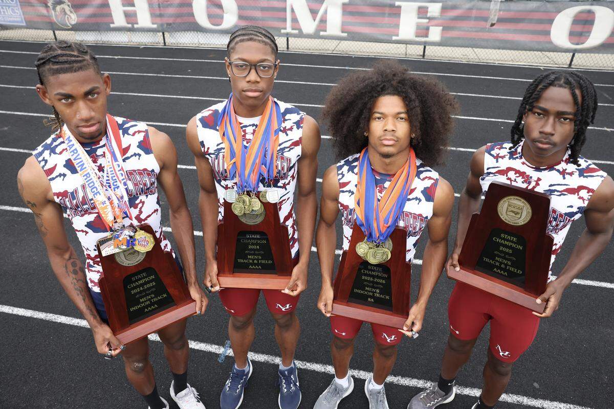 From left, Roderick Orr, Nyan Brown, Mason Kelley and Josiah Vaden hold track championship trophies Monday, May 11, 2026 at Mallard Creek High School.