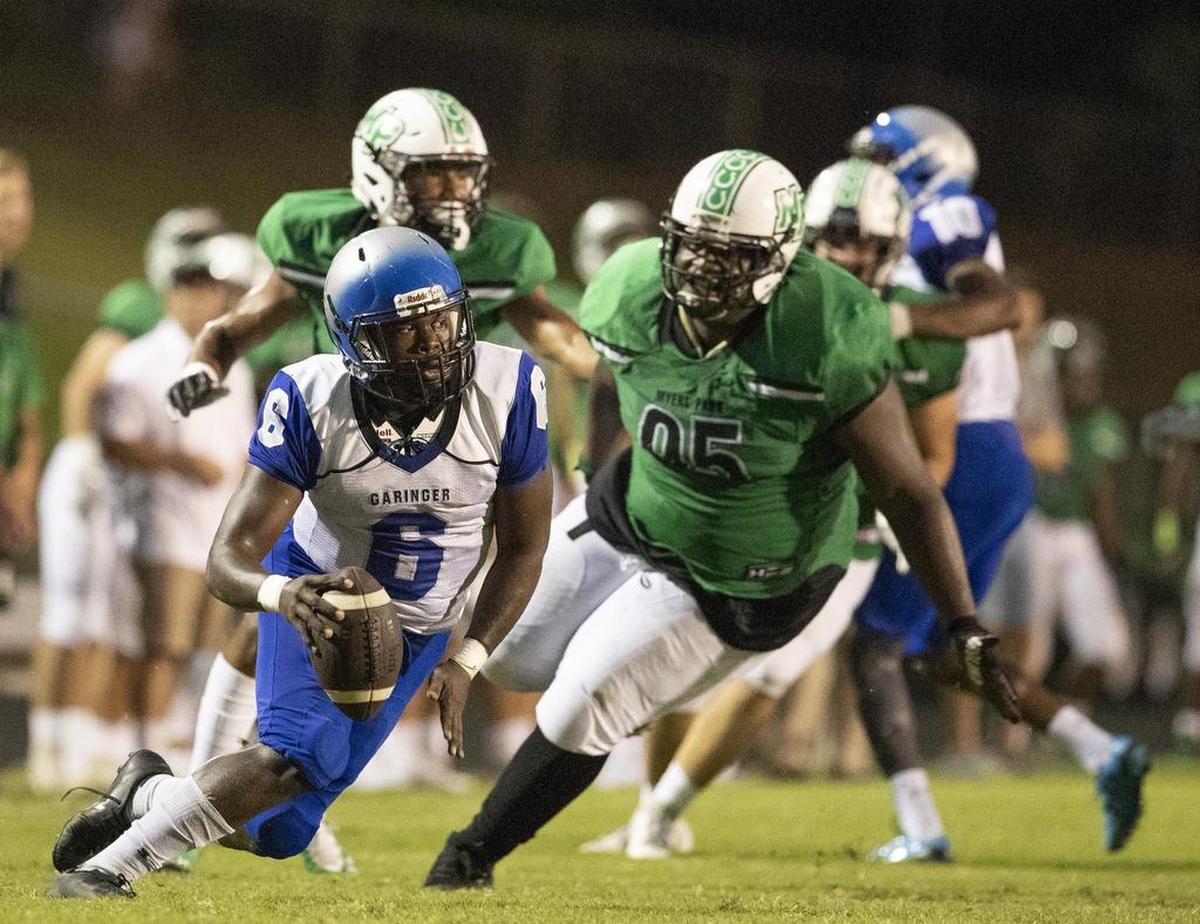 Garinger quarterback Antonio Smith scrambles against the Myers Park defense during a prep football game at Myers Park High School Friday, September 21, 2018 in Charlotte, NC. Photo by JASON E. MICZEK - Special to the Observer