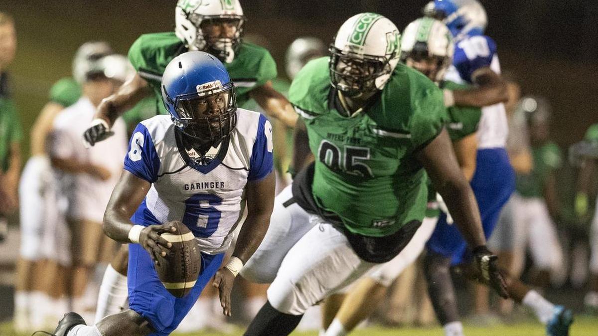 Garinger quarterback Antonio Smith scrambles against the Myers Park defense during a prep football game at Myers Park High School Friday, September 21, 2018 in Charlotte, NC. Photo by JASON E. MICZEK - Special to the Observer