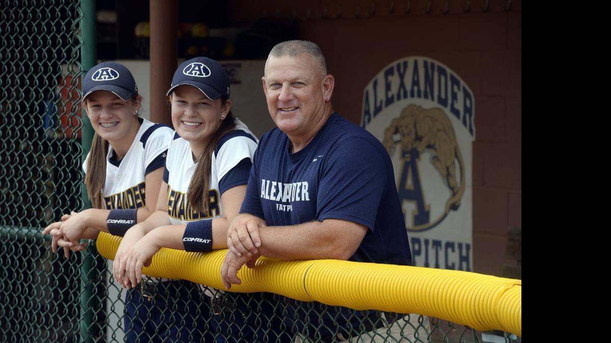 
Alexander Central softball tied the N.C. record for consecutive wins at 83 Friday, led by coach Monte Sherrill (right). In this 2014 photo, Sherrill is flaked by his two daughters. Bailey (center), who beat cancer at 6, is now playing at Pfeiffer. Vada, a senior, was N.C. Gatorade player of the year last season and has led the team to a 17-0 start this season.


