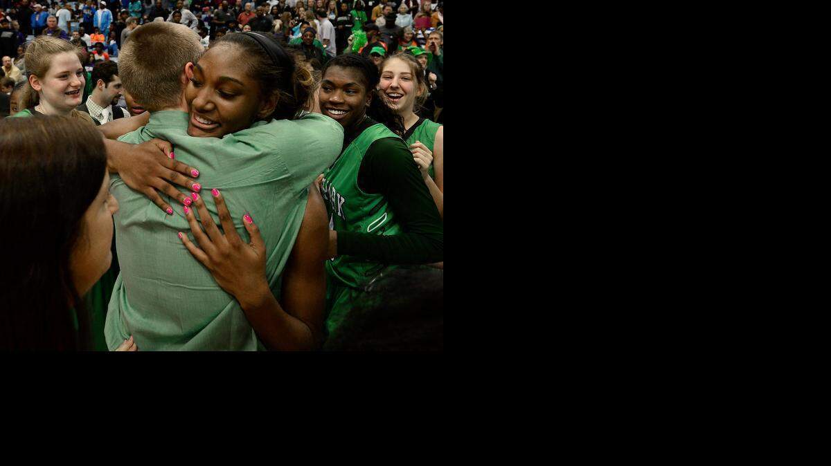 
Myers Park’s D.D.  Rogers (32) is hugged following the team’s victory over Southeast Raleigh in the NCHSAA 4A Girls Championship game at the Dean E. Smith Center in Chapel Hill. Myers Park defeated Southeast Raleigh 52-47. 
