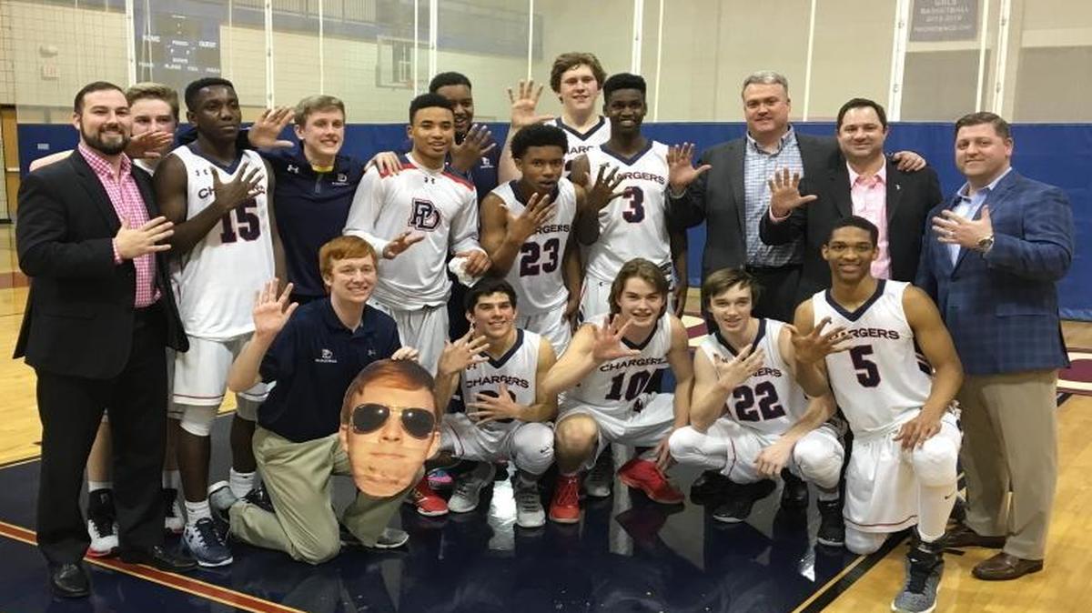 Providence Day’s boys celebrate winning their fifth straight CISAA conference championship. The Chargers are 40-1 during the run