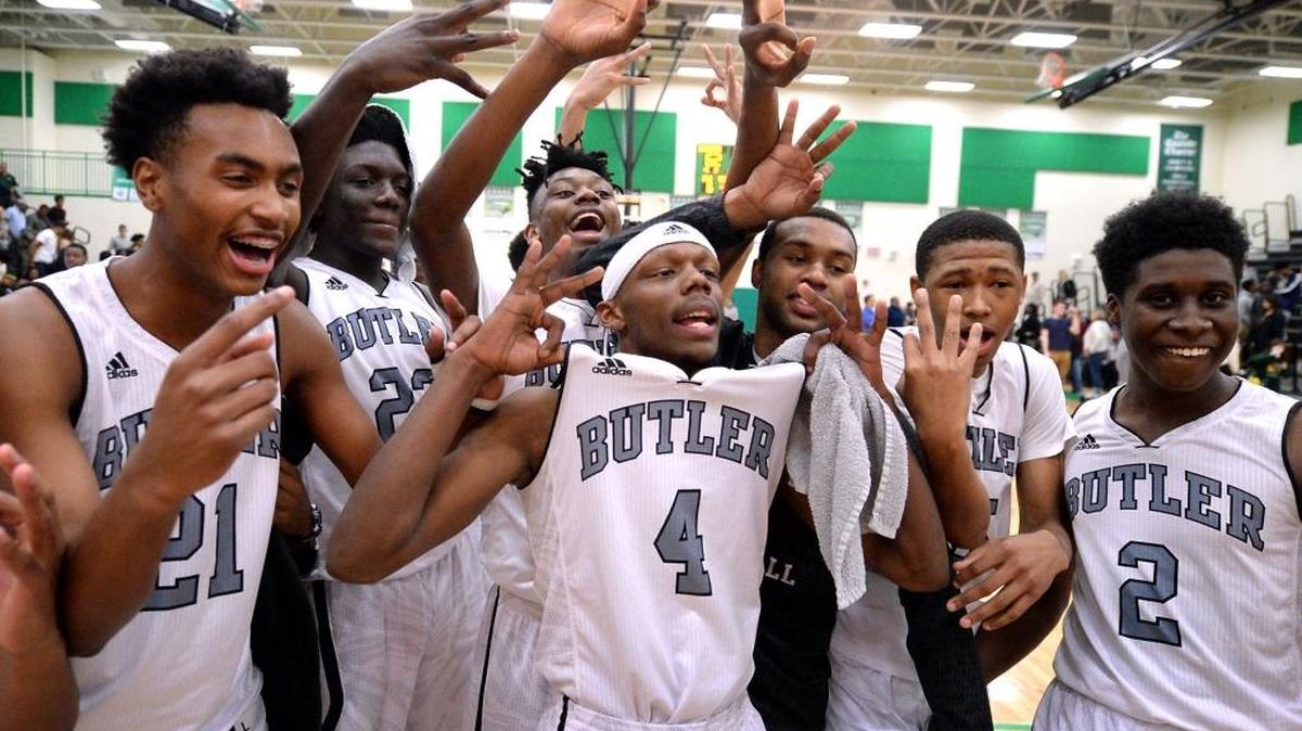 The Butler Bulldogs celebrate their victory over the Independence Patriots in the Southwestern 4A championship game action at Myers Park High School on Friday, February 17, 2017. The Bulldogs defeated the Patriots 62-37.