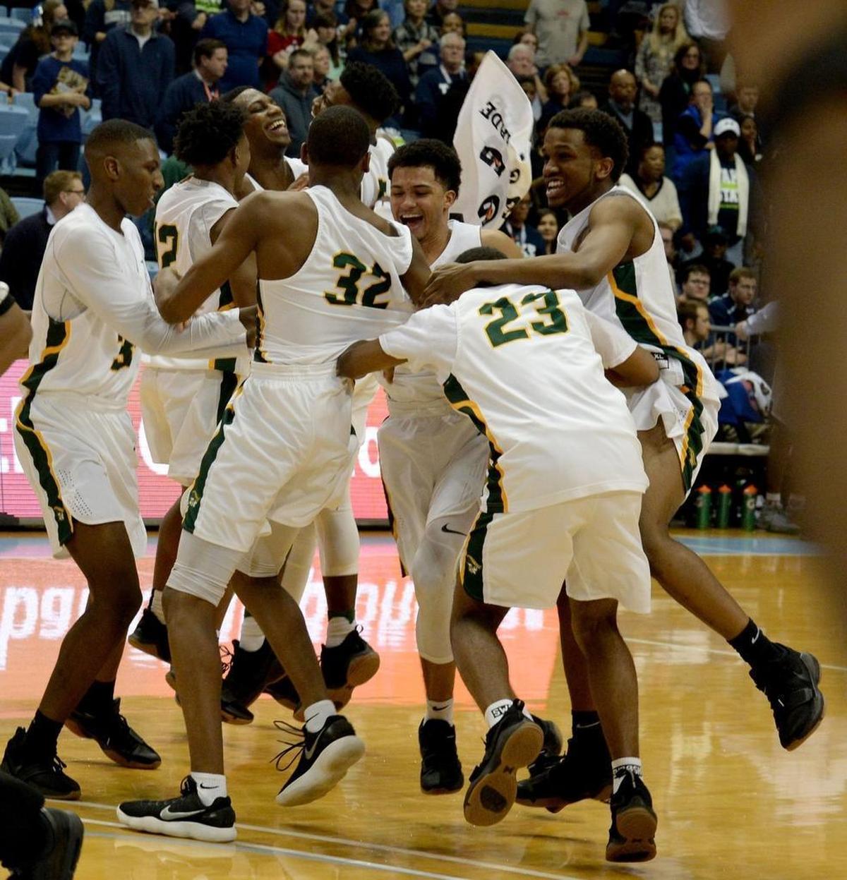 Independence players celebrate winning the state championship over Heritage after Saturday evening's NCHSAA state basketball championship 4A game between Independence and Wake Forest Heritage at the Smith Center in Chapel Hill.