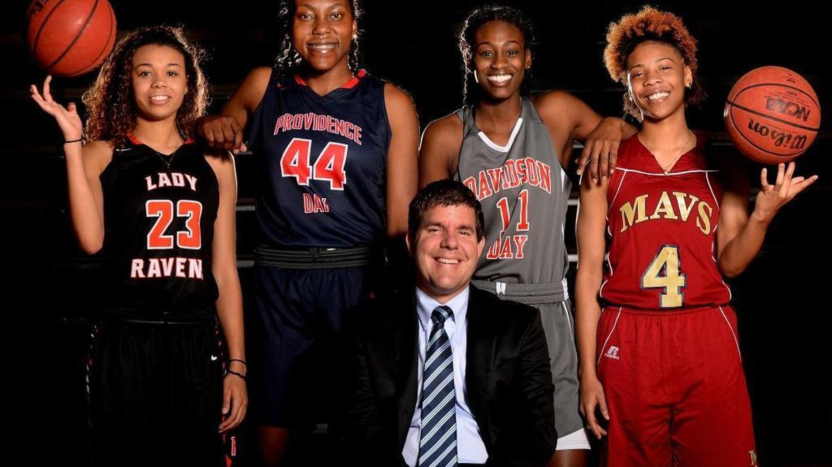 All-Mecklenburg girls’ basketball team (left to right, back row): Ariana Nance, Rocky River; Janelle Bailey, Providence Day; Maya Caldwell, Davidson Day; and Dazia Lawrence, Mallard Creek. The coach of the year is Providence Day’s Josh Springer (seated). Not pictured: Ahlana Smith, Mallard Creek