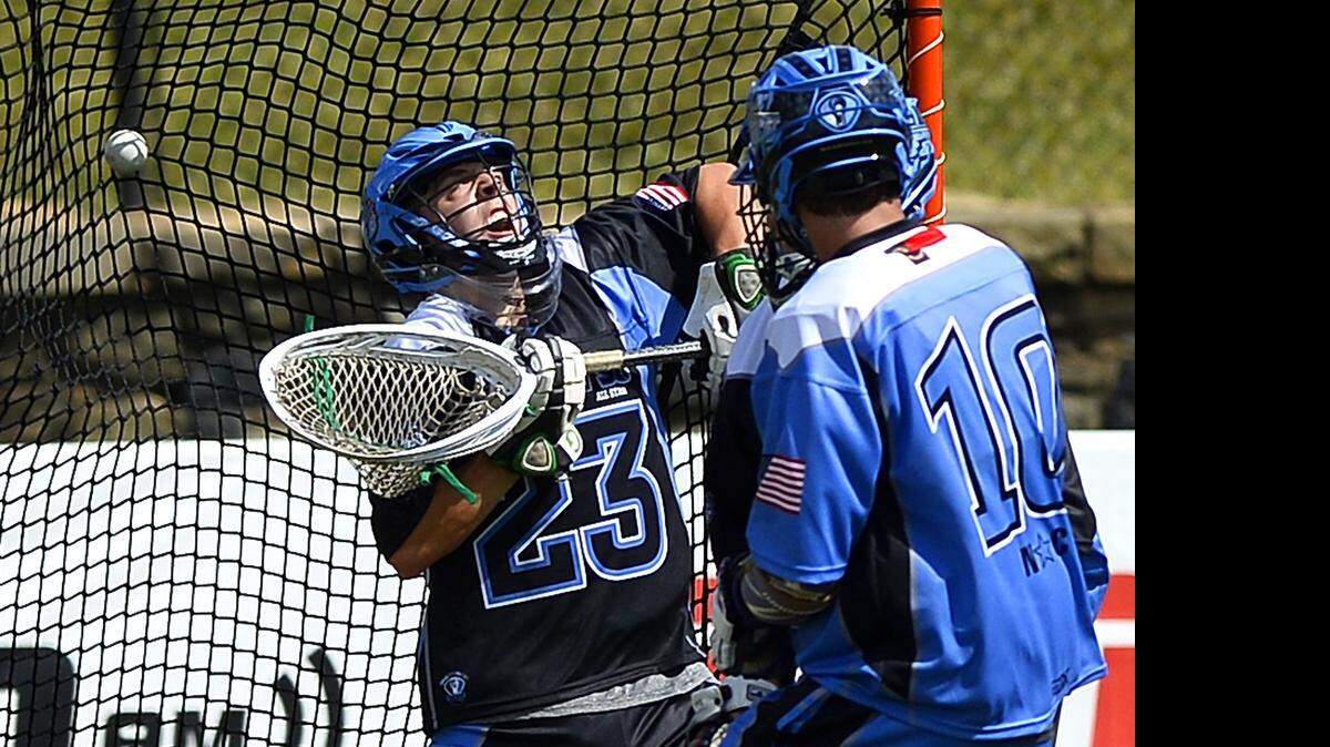 
Team Black's Kevin McKendry, left, is unable to stop a goal by Team Blue's Walker Rice, right, during the Great 38 N.C. Prep All Star lacrosse match at Memorial Stadium on Saturday, May 30, 2015. Team Blue defeated Team Black 15-13.

