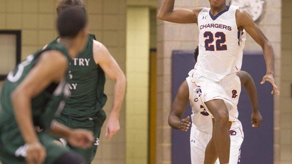 Providence Day's Isaac Johnson (22) passes down court while facing Country Day during a boys prep basketball game Friday, January 5, 2016 at Providence Day. Photo by JASON E. MICZEK - Special to the Observer