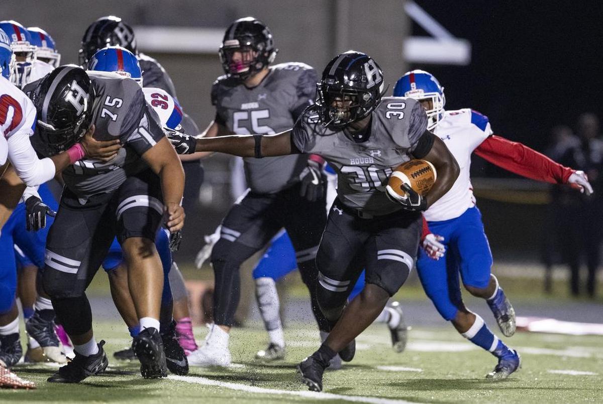 Hough ball carrier Kwesi Kyei-Fordjour (30) looks for running room against North Meck on Friday.
