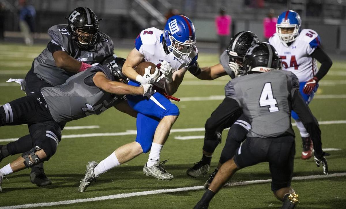 North Meck wide receiver Justin Olson (2) tries to break away from Hough’s defense Friday night.
