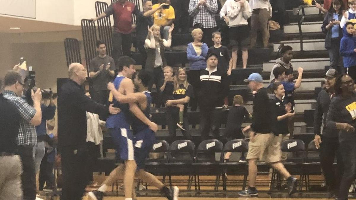 Carmel Christian’s Jake Boggs celebrates with Ford Cooper after Carmel rallied to beat Gaston Day in the NCISAA state finals
