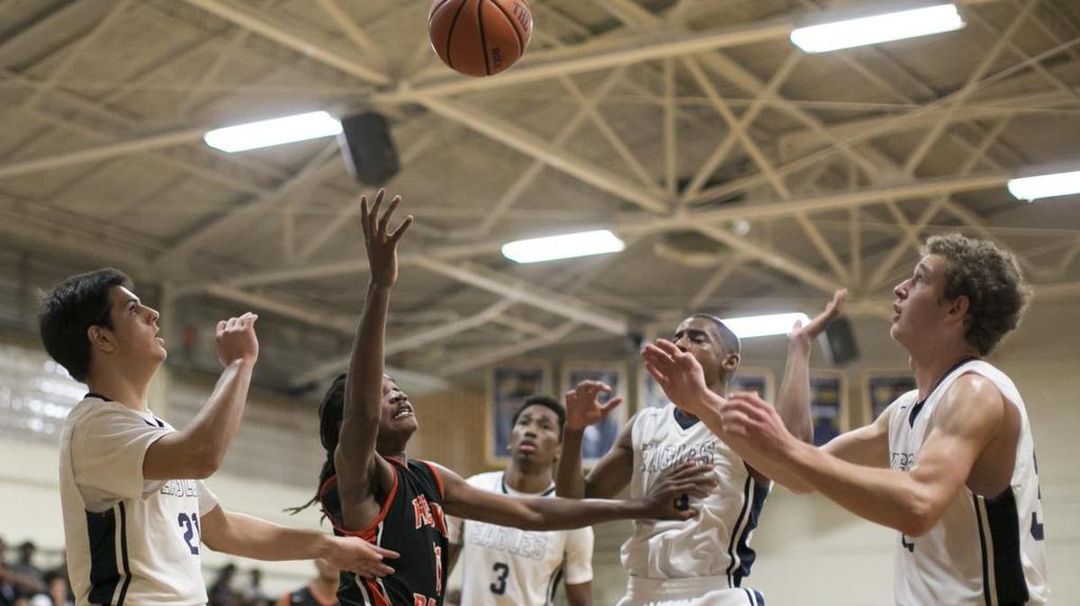 East Meck's Joe Richards, left, and Jared Dowless, right, try to grab a loos ball from Rocky River's Rayquan Brown (11) during a prep basketball game Tuesday, December 15, 2015 at East Meck High School. JASON E. MICZEK - Special to the Observer