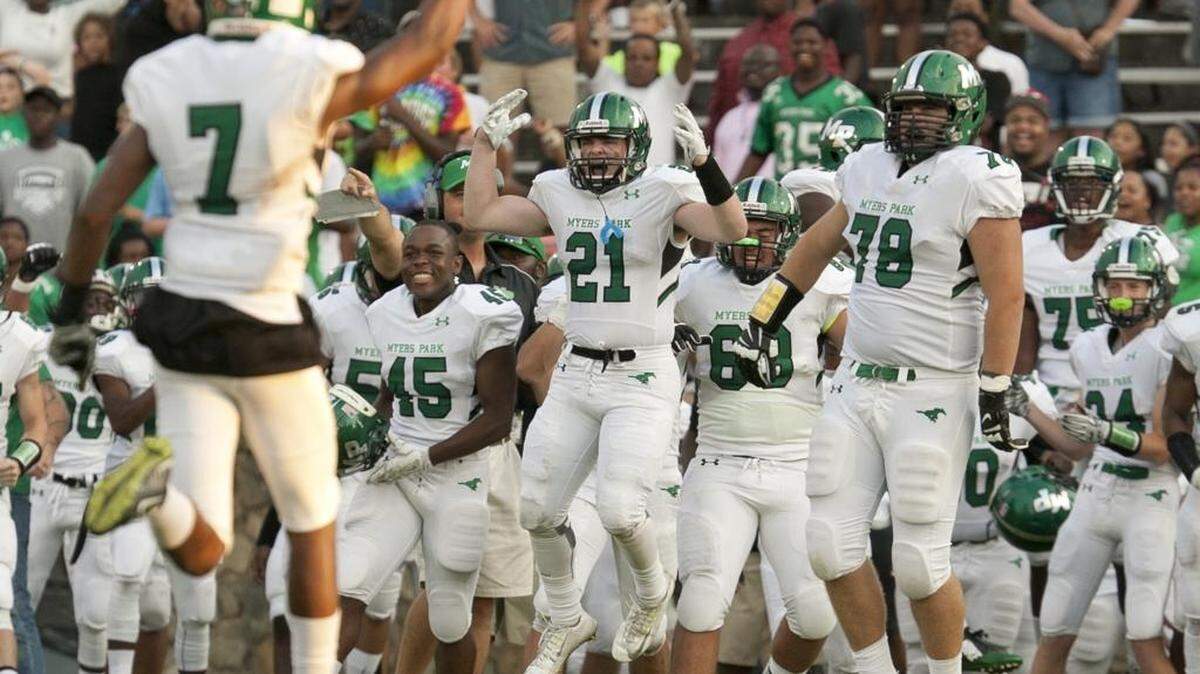 
William Atkinson (21) and the rest of the Myers Park bench celebrate as the final seconds tick down on Saturday’s game against against Charlotte Country Day at Memorial Stadium. Myers Park won 19-14. For more high school football coverage, go to www.charlotteobserver.com/sports/high-school/.
