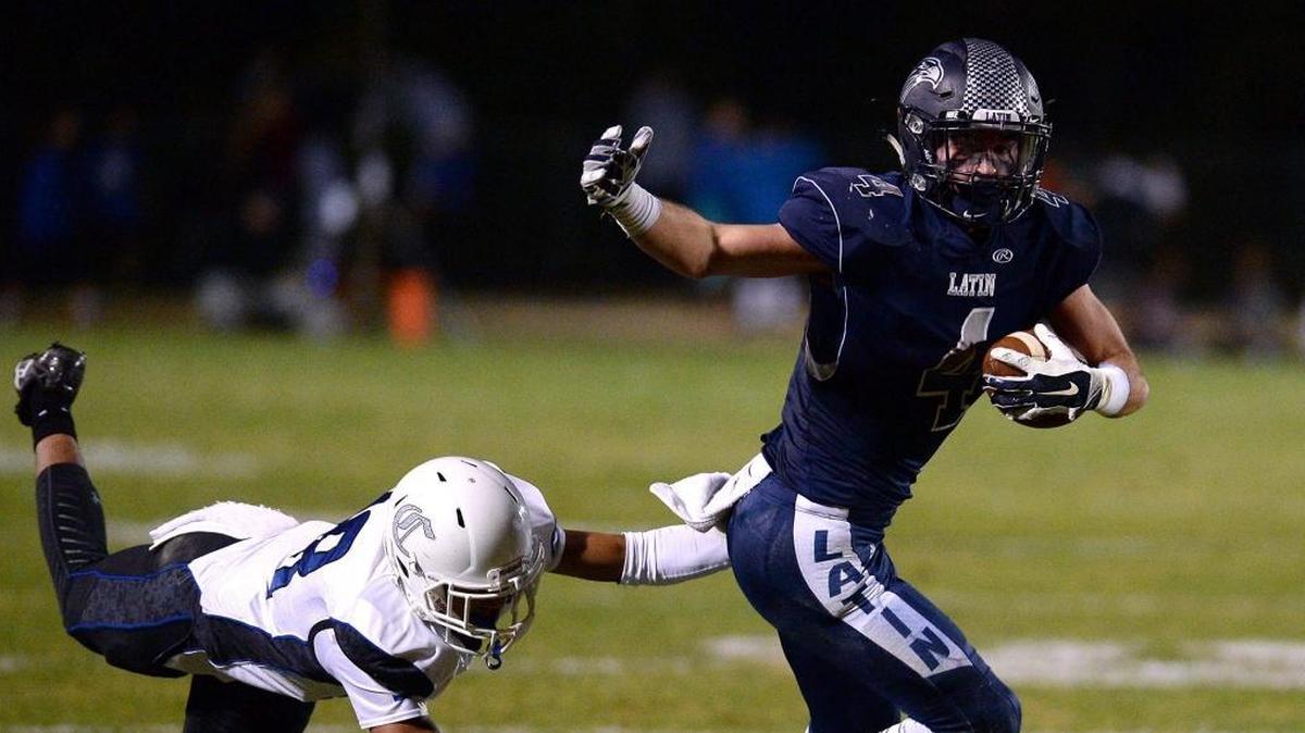 Charlotte Latin wide receiver Christopher Elliott, right, escapes the grasp of Charlotte Christian defensive back Austin Israel, left, during second quarter action in the NCISAA football championship game at Charlotte Latin School on Friday, November 11, 2016.