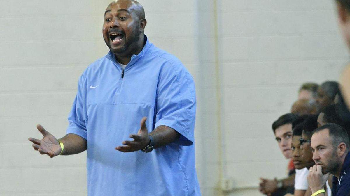 Hopewell head coach, Damon Bost, exhorts his team in the first half against Grace Crhristian Saturday. Grace Christian's boys faced off against Hopewell High School in an early game on Saturday, Nov. 28, 2015. Hopewell's Titans defeated the Grace Christian Rams 66-56.
