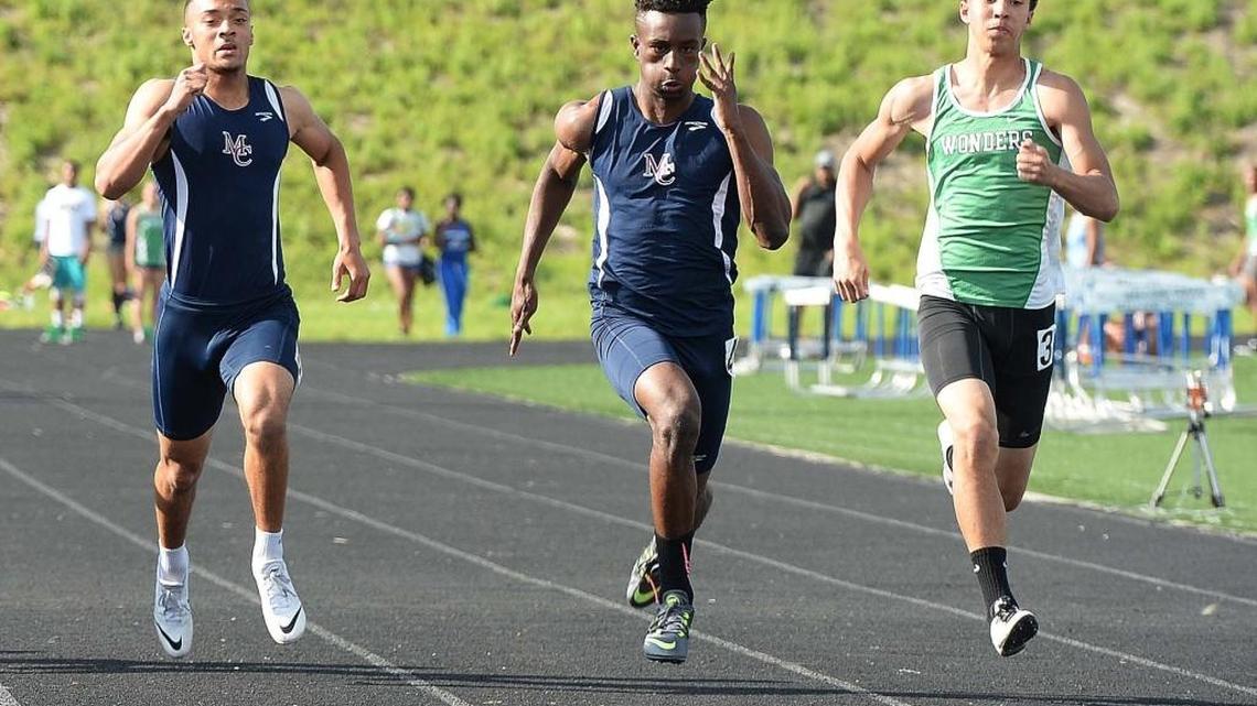 From left, Mallard Creek's Kyle Horton finishes third, Mallard Creek's Cravont Charleston finishes first, A.L. Brown's Brylan Weaks finishes second,in the 100 meter dash during the MeckA conference championship track meet held at Mallard Creek high school April 22,2015.