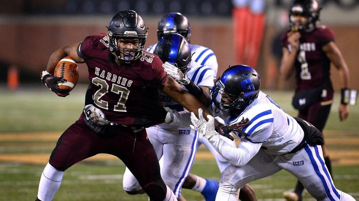 Harding University running back Quavaris Crouch, left, battles to get free of a Scotland County defender on a run during first-half action in the NCHSAA 4A state Championship game at BB&T Field in Winston-Salem, NC on Saturday, December 9, 2017.