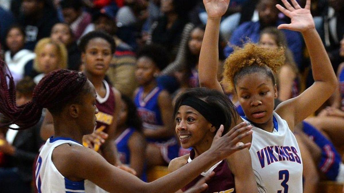 West Charlotte's Damolia China, center, looks to pass to a teammate as North Meck's Jayla Wilson, left and Courtney Lewis, right, apply defensive pressure during second half action on Friday, December 8, 2017 at North Meck High. North Meck defeated West Charlotte 66-26.