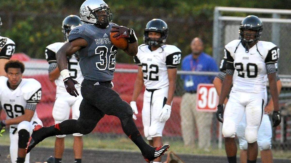 
Butler Bulldogs running back Benjamin LeMay rushes past the Hough sidelines on an 87-yard touchdown run during first half action at Butler High School on Friday. 
