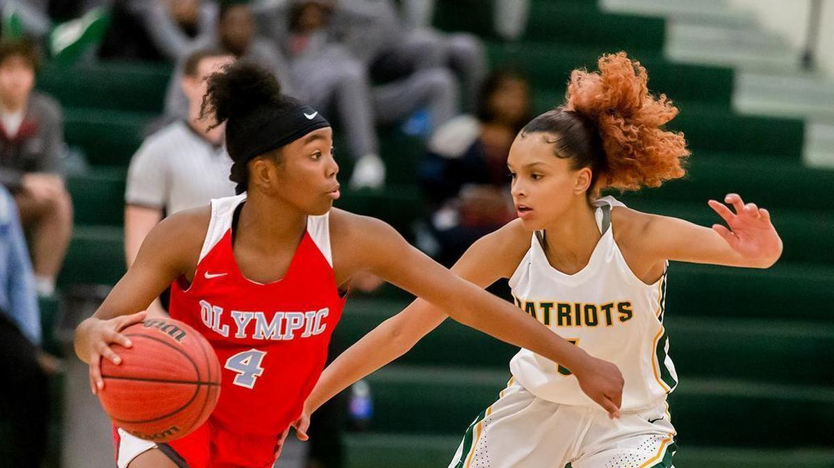 Olympic's Moriah Terry (center) looks to drive the lane during late second quarter action at Independence High Tuesday.