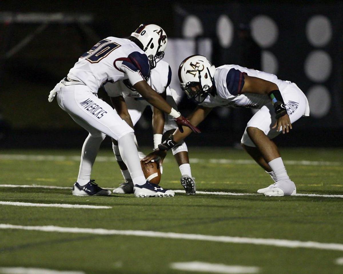 Mallard Creek players down a punt on fourth down in the first half of Friday’s game with Hough.