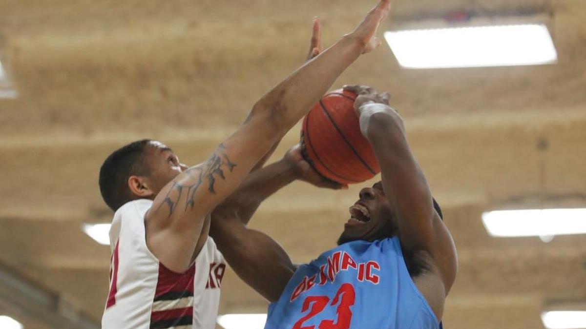 Olympic's Jalen Barr goes strong to the basket only to be denied by Harding's Quinten Thomas.