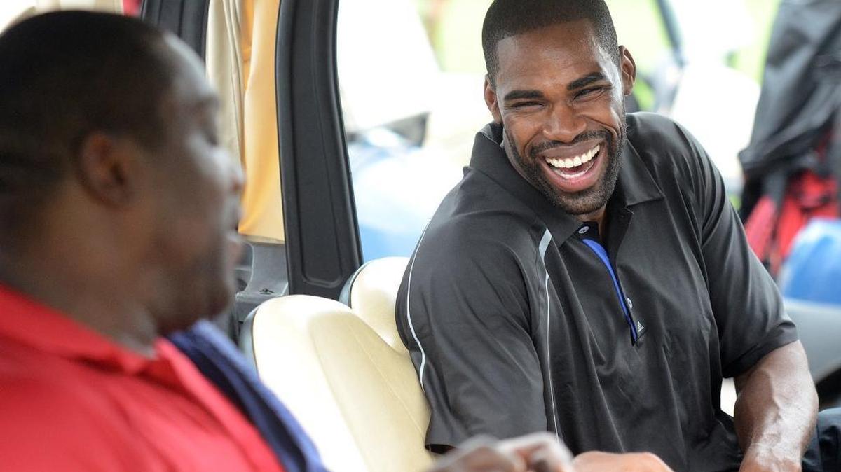 Former NFL player, Warren Sapp (left) jokes with Antawn Jamison (right), a former Tar Hell and current NBA player, as they wait to begin play at the HoopTee Golf Classic. Celebrities like Dell Curry, Moses Malone, Antawn Jamison, Ed "Too Tall" Jones, Wesley Walls, Charles Oakley and Warren Sapp, among others played in the 12th annual HoopTee Golf Classic at The Golf Club at Ballantyne Thursday July 10, 2014. The event is hosted by its founder Fred Whitfield of the Charlotte Hornets.