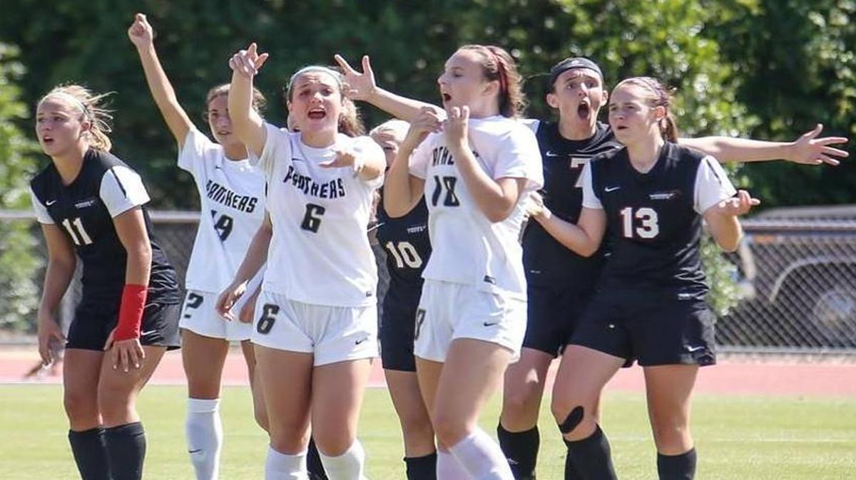 Players from Middle Creek (in black uniforms) and Providence react to the offsides call that waved off a tying Middle Creek goal scored in the final seconds of Saturday’s N.C. 4A girls’ soccer championship in Raleigh. Providence won 2-1.