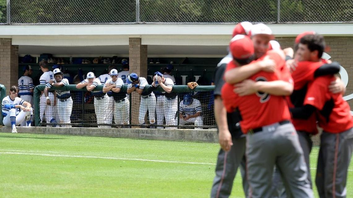 Charlotte Christian baseball players watch in dejection as Wesleyan Christian Academy baseball players celebrate winning over Charlotte Christian in the NCISAA 3A state championship baseball game at Charlotte Country Day Saturday afternoon.