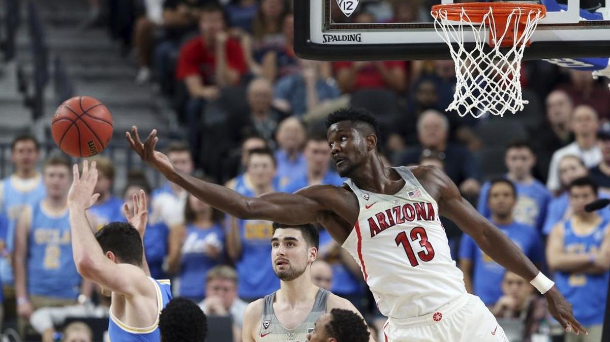 Arizona's Deandre Ayton (13) reaches for a rebound during the second half of the team's NCAA college basketball game against UCLA in the semifinals of the Pac-12 men's tournament Friday, March 9, 2018, in Las Vegas. Arizona won 78-67 in overtime. (AP Photo/Isaac Brekken)