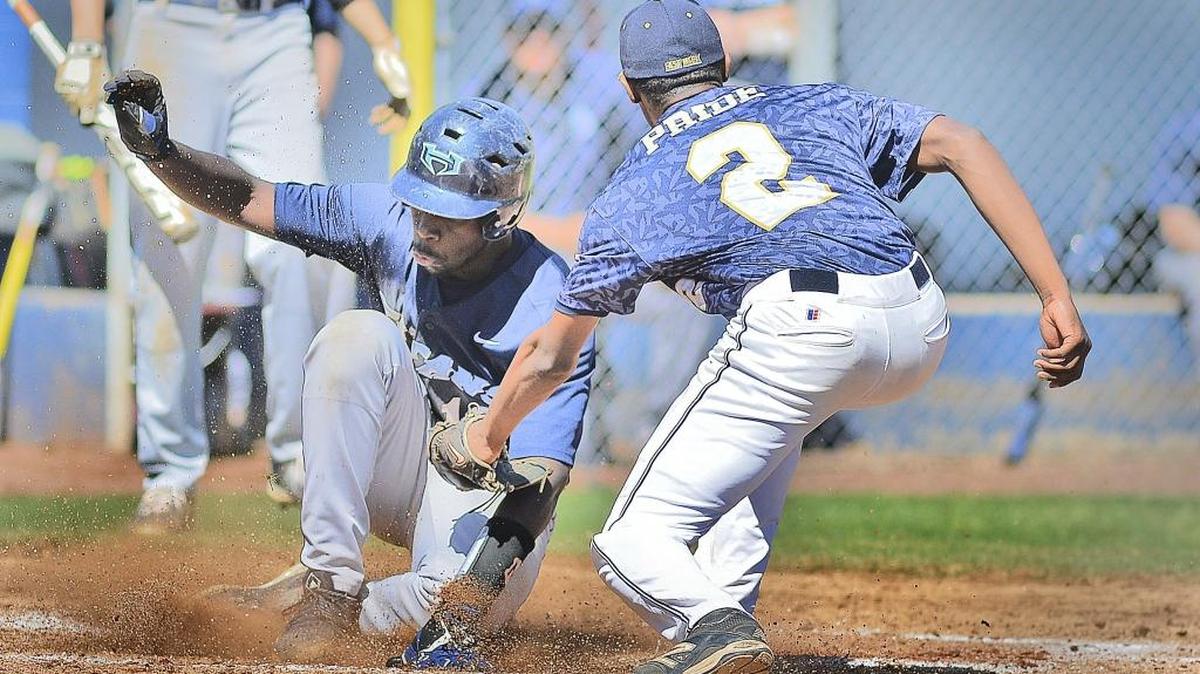 Hopewell's Leon Davidson slides safely into home-base as East Meck's Derrick Rabb attempts to tag him out. The 2nd Annual Jack Sink Spring Break Classic got underway at East Meck Monday.