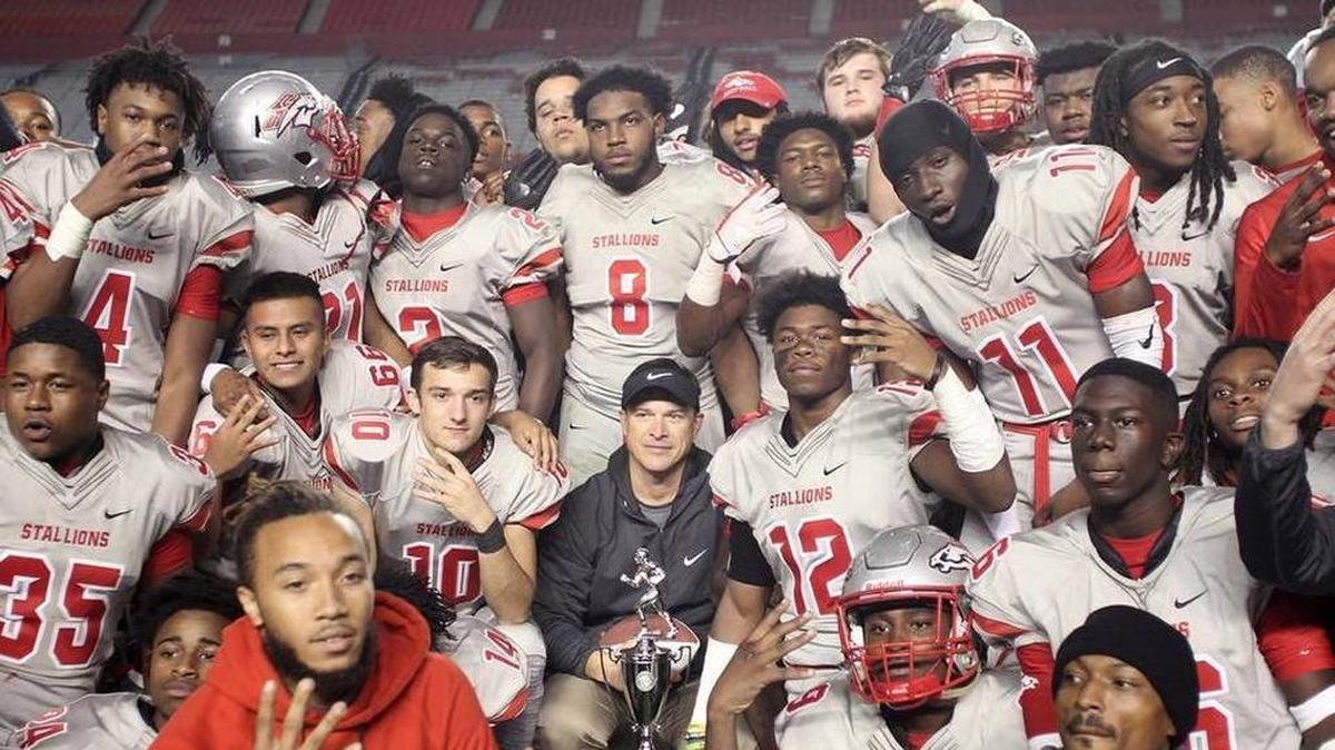 South Pointe football coach Straight Herron, center, celebrated a fourth straight state title this month with team. He’s one of six finalists for a national coach of the year award